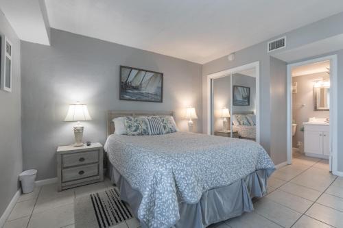a bedroom with a large bed and a bathroom at Island Shores 654 in Gulf Shores