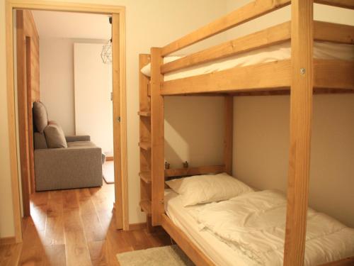 a bedroom with two bunk beds and a chair at Appartement Châtel, 2 pièces, 4 personnes - FR-1-200-372 in Châtel