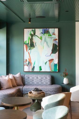 a living room with a couch and a painting on the wall at Hutton Hotel in Nashville