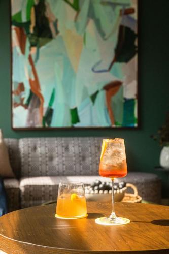 a glass of orange juice sitting on a wooden table at Hutton Hotel in Nashville