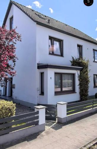 a white house with a black roof at Ferienwohnung am Freudenthal in Soltau