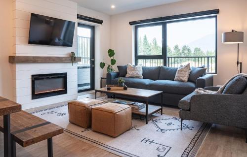 a living room with a couch and a fireplace at Glades and Greens by Revelstoke Vacations in Revelstoke