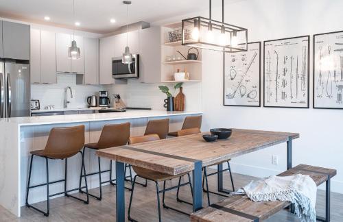 a kitchen with a wooden table and chairs at Glades and Greens by Revelstoke Vacations in Revelstoke