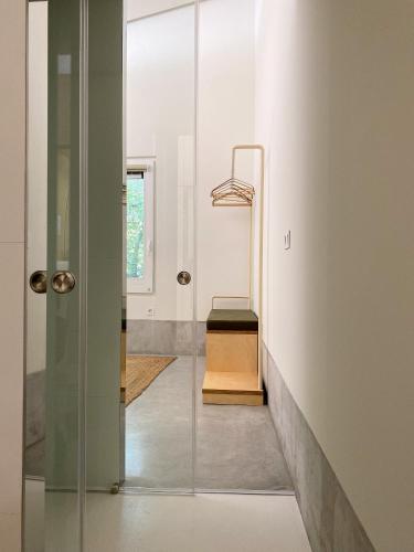 a room with a glass door with a bench in it at Casa do Rio in Leiria