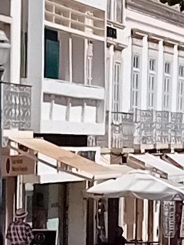 a black and white photo of umbrellas on a city street at T3 2 Andar Ref 007 in Tavira