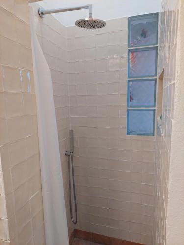 a shower with a shower curtain in a bathroom at Cosy Terrace House - design, comfort, micro-pool, top location in Olhão in Olhão