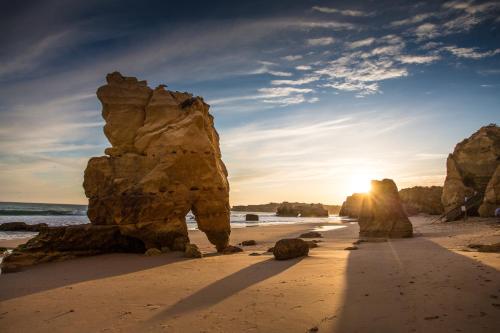 a group of large rocks on a beach at AlvorMar Apartamentos Turisticos in Alvor