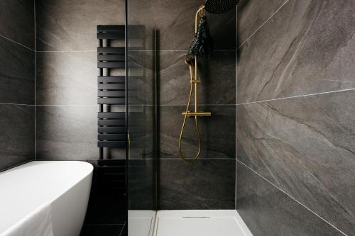 a bathroom with a shower and a toilet at The Edgewater Suites - SKYLINE in Namur