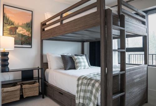 a bedroom with a wooden bunk bed with at The Monashee House by Revelstoke Vacations in Revelstoke