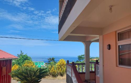 a view of the ocean from the balcony of a house at Sea View Guest Accommodation in Roseau