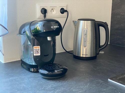 a coffee maker and a kettle on a counter at Top class apartments in Carlsbad Bulharska street in Karlovy Vary