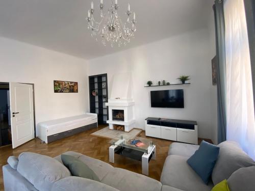 a living room with a couch and a chandelier at Top class apartments in Carlsbad Bulharska street in Karlovy Vary