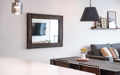 a living room with a mirror and a table at The Selkirk House by Revelstoke Vacations in Revelstoke