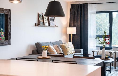 a living room with a couch and a table at The Selkirk House by Revelstoke Vacations in Revelstoke