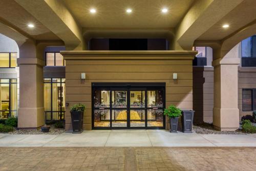 a front door of a building with two potted plants at Hampton Inn & Suites by Hilton Walla Walla in Walla Walla
