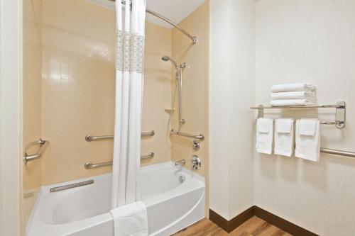 a bathroom with a shower and a bath tub with towels at Hampton Inn & Suites by Hilton Walla Walla in Walla Walla