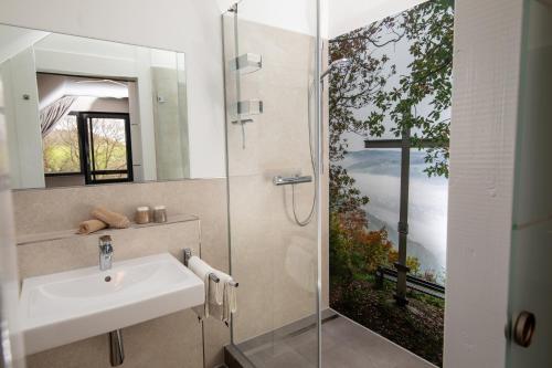 a bathroom with a sink and a shower at Landgasthof Zur Erholung in Breitscheid