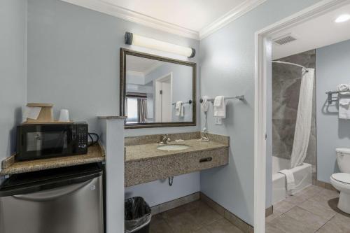 Motel 6 Carlsbad, Ca- North في كارلسباد: حمام مع حوض وميكروويف