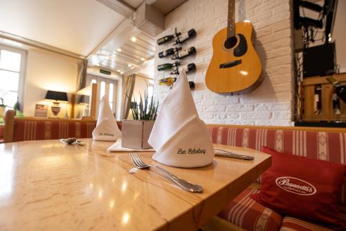 a wooden table with napkin boats on top of it at Landgasthof Zur Erholung in Breitscheid
