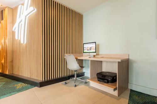an office with a desk with a computer and a chair at Holiday Inn Oxford by IHG in Oxford