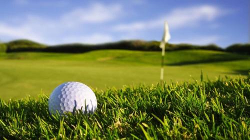 a golf ball sitting in the grass next to a golf course at Crowne Plaza Executive Center Baton Rouge by IHG in Baton Rouge