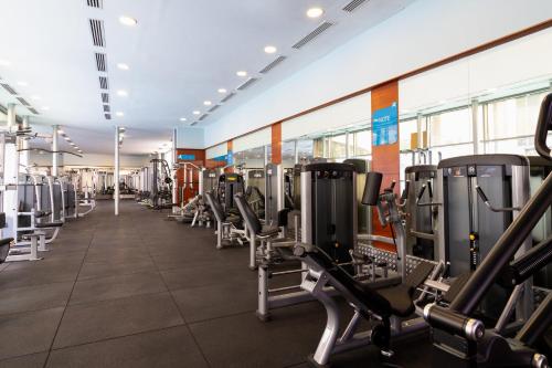 a gym with rows of treadmills and machines at Holiday Inn Kuwait by IHG in Kuwait