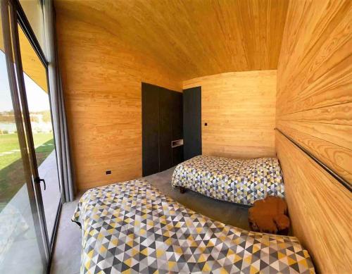 a small room with two beds and a window at Parcela Casas Modernas Alto la Campana in Granizo