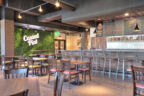 a restaurant with tables and chairs and a bar at Holiday Inn & Suites Pigeon Forge Convention Center by IHG in Pigeon Forge