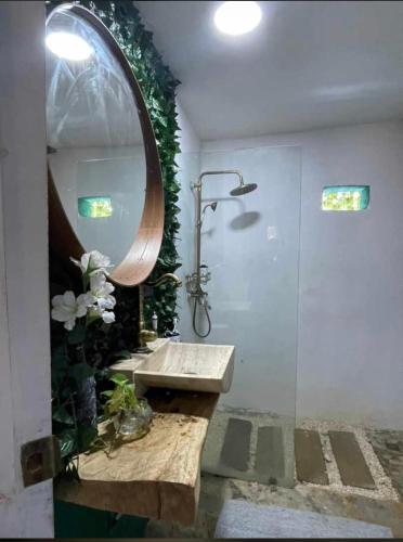 a bathroom with a sink and a mirror at Dreamvilles Ecovillage Las Galeras in Las Galeras