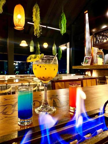 a table with two glasses of drinks on a bar at Hotel Wayra Club in Acacías