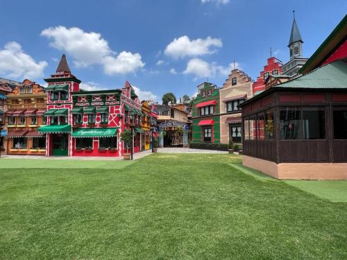 a group of colorful buildings with a grass yard at Villa Claus Inn in Tlalpujahua de Rayón