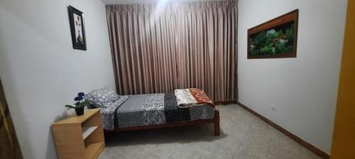 a bedroom with a bed and a large window at CASA TESORITOS in Urbanizacion Buenos Aires