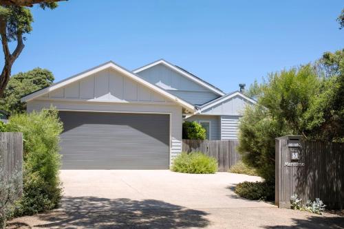 a white house with a garage at Marittimo in Point Lonsdale