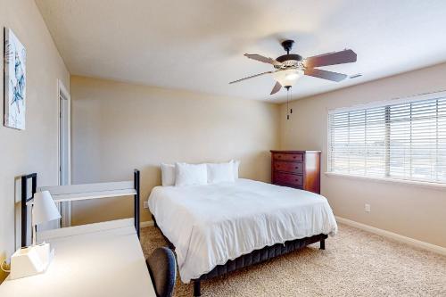 a bedroom with a bed and a ceiling fan at Cedar Park Oasis in Cedar City