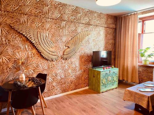 a living room with a wall with a peacock mural at Unique 40t apartment @UB center in Ulaanbaatar