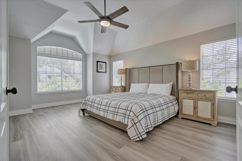 a bedroom with a bed and a ceiling fan at Woodlands Contemporary 4BR3Bath with heated Pool and Spa in The Woodlands
