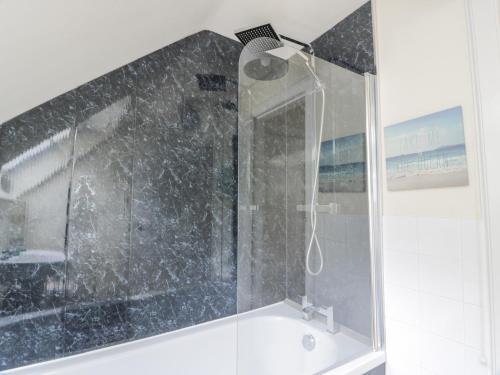 a shower in a bathroom with a glass door at Rose Cottage in Melrose