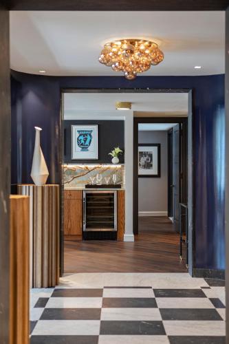 a living room with a fireplace and a chandelier at JW Marriott Essex House New York in New York