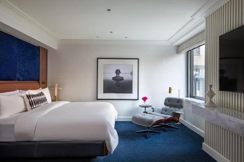 a bedroom with a large white bed and a window at JW Marriott Essex House New York in New York