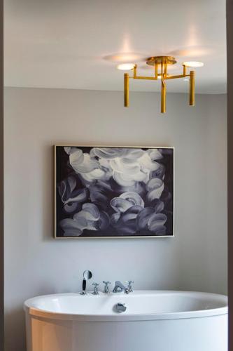 a bathroom with a sink and a painting on the wall at JW Marriott Essex House New York in New York