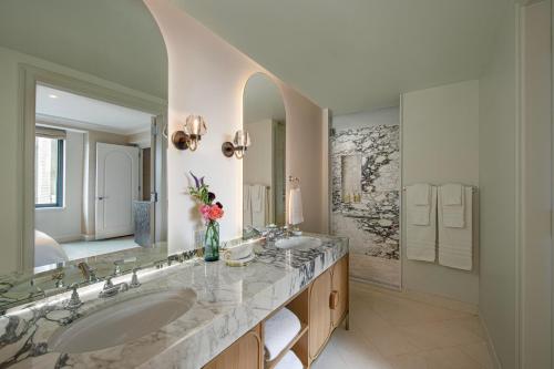a bathroom with two sinks and a large mirror at JW Marriott Essex House New York in New York