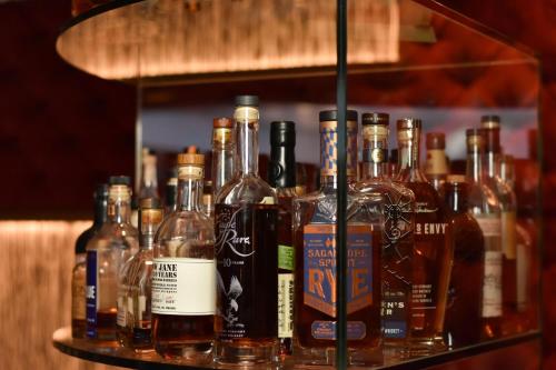 a shelf filled with lots of bottles of alcohol at Cologne Marriott Hotel in Cologne