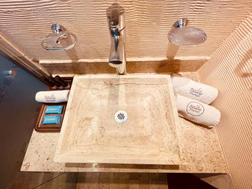 a bathroom with a sink with towels on it at La Estancia in San Cristóbal de Las Casas