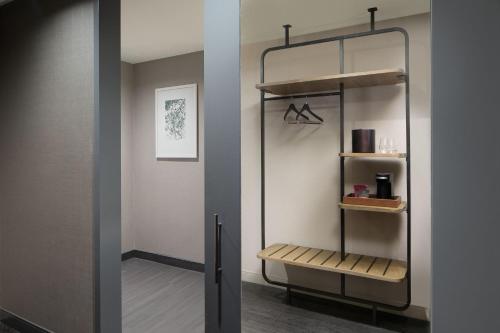 a bathroom with a shower with a glass door at Marriott Dallas Uptown in Dallas