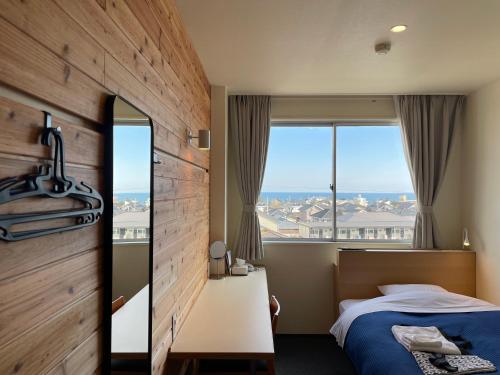 Ένα ή περισσότερα κρεβάτια σε δωμάτιο στο Hitachi Hotel Crane