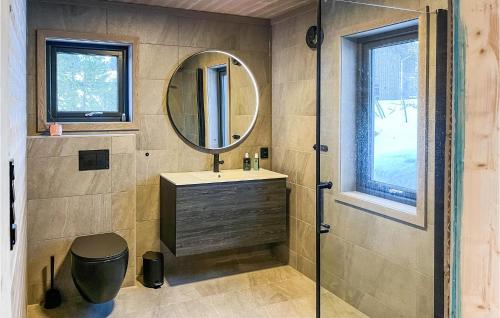 W łazience znajduje się umywalka i lustro. w obiekcie Nice Home In Edland With Wifi w mieście Botn