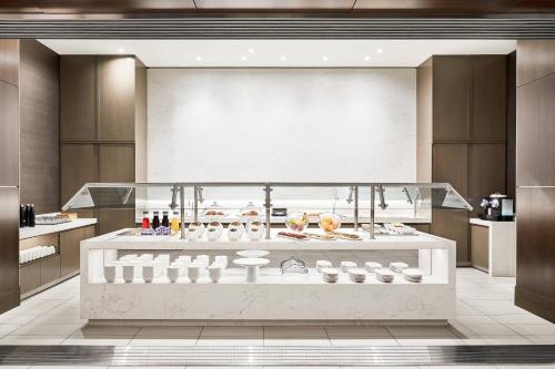 a restaurant with a counter with food on it at AC Hotel by Marriott Beverly Hills in Los Angeles