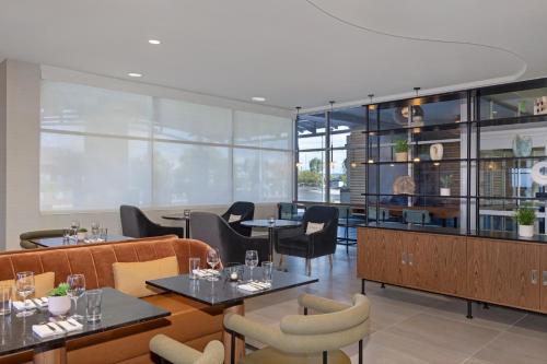 a restaurant with tables and chairs and windows at DoubleTree by Hilton Las Vegas East Flamingo in Las Vegas