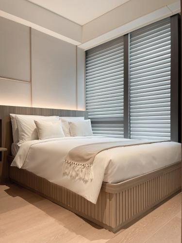 a bedroom with a large bed and a large window at The Stellar in Hong Kong