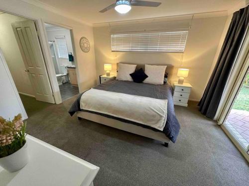 a bedroom with a bed and a ceiling fan at Sandstone Point and Bribie Beaches in Sandstone Point